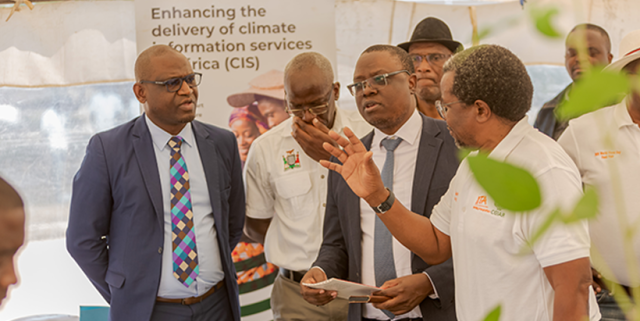 Dr David Chikoye guiding the Presidential Delivery Unit delegation through the exhibition